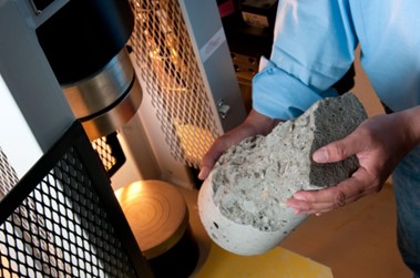 Concrete being strength tested in a lab